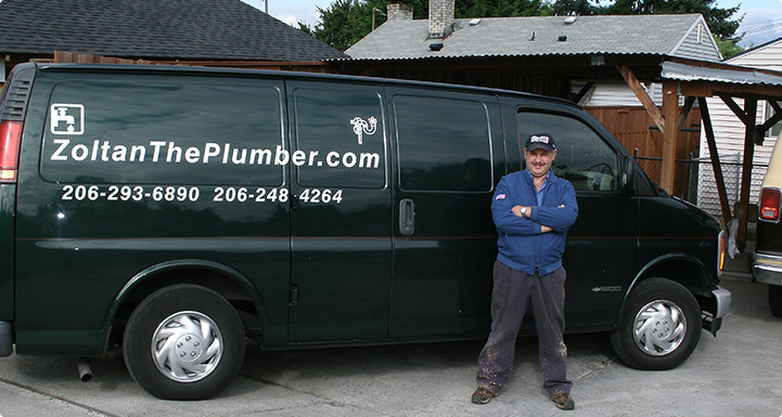 Zoltan The Plumber standing with arms crossed in front of his green van lettered ZoltanThePlumber.com with both phone numbers
